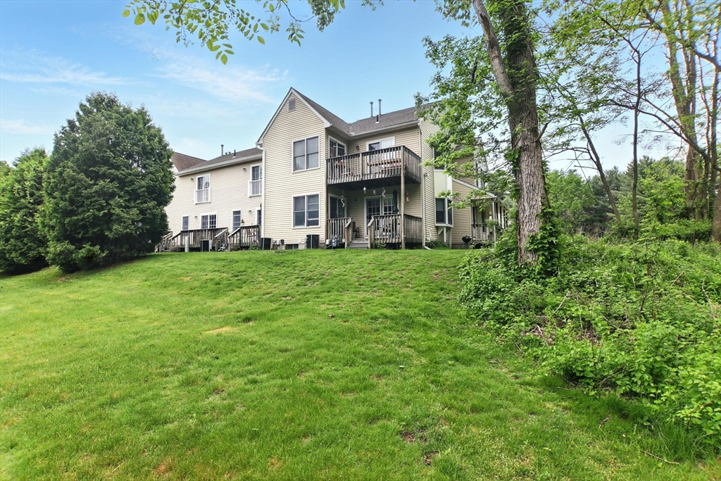 59 Castlegate Drive, Unit B Springfield, MA 01129 - Photo 36 of 42 a view of a house with a big yard and large trees