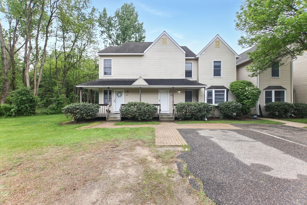 59 Castlegate Drive, Unit B Springfield, MA 01129 - Photo 8 of 42 a front view of a house with a yard and trees
