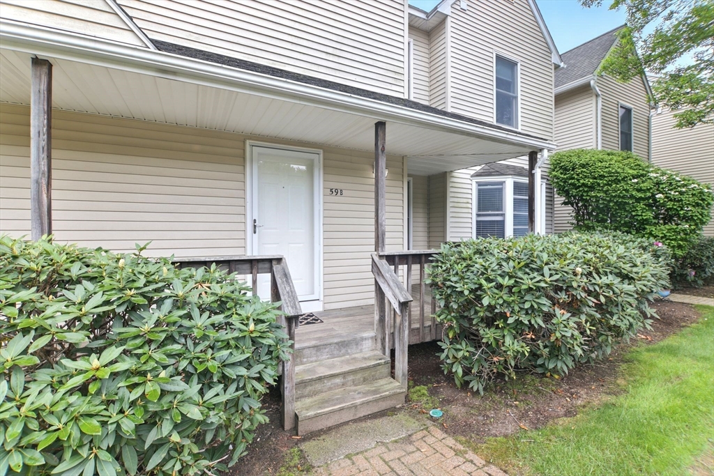 59 Castlegate Drive, Unit B Springfield, MA 01129 - Photo 10 of 42 front view of a house with a garden