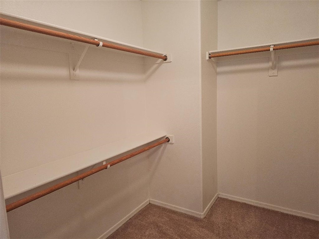 1069 Teddy Roosevelt Road Golden Valley, AZ 86413 - Photo 12 of 24 Spacious closet featuring dark colored carpet