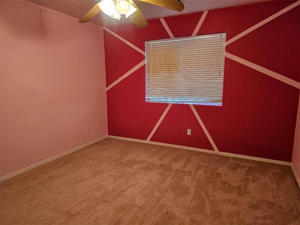 1069 Teddy Roosevelt Road Golden Valley, AZ 86413 - Photo 14 of 24 Empty room featuring ceiling fan and carpet floors