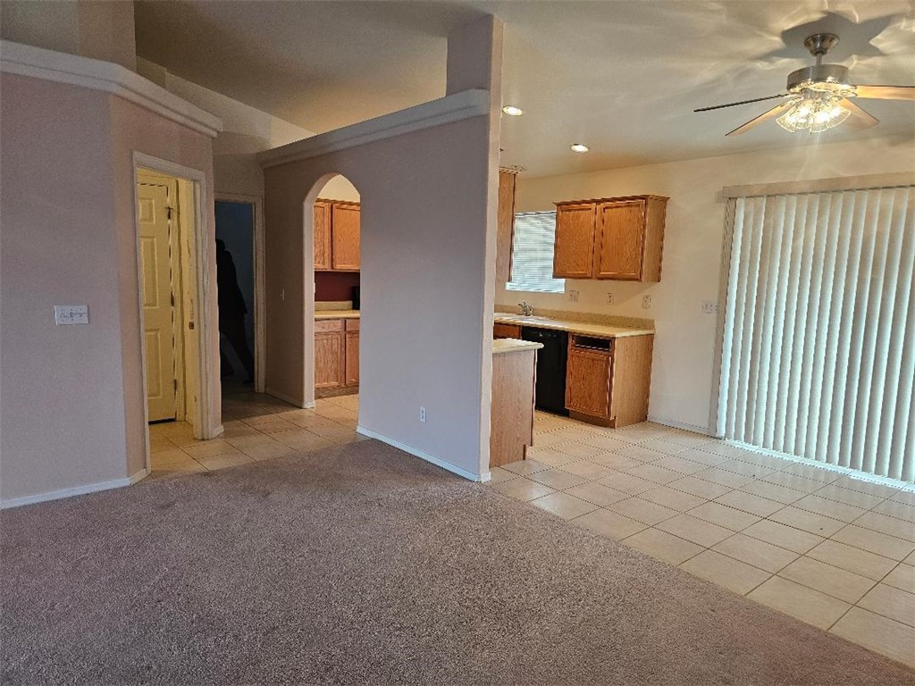 1069 Teddy Roosevelt Road Golden Valley, AZ 86413 - Photo 16 of 24 Kitchen with light tile patterned floors, arched walkways, brown cabinetry, light countertops, and recessed lighting