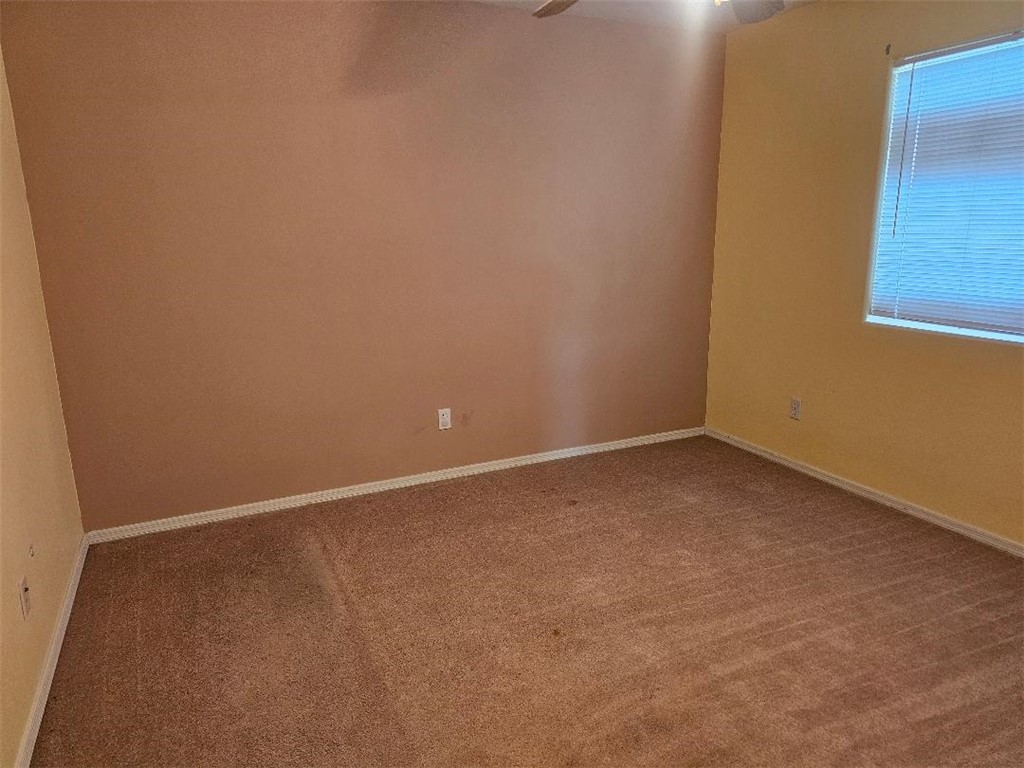 1069 Teddy Roosevelt Road Golden Valley, AZ 86413 - Photo 17 of 24 Carpeted empty room featuring baseboards and ceiling fan