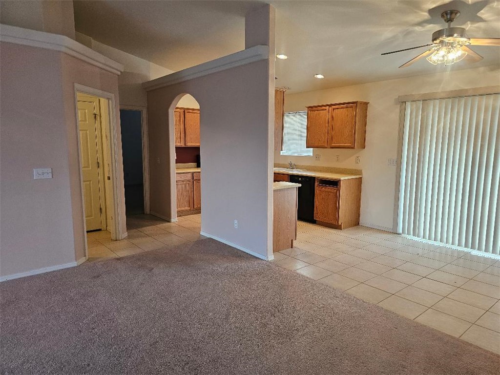1069 Teddy Roosevelt Road Golden Valley, AZ 86413 - Photo 18 of 24 Kitchen featuring light tile patterned floors, light countertops, arched walkways, light carpet, and recessed lighting