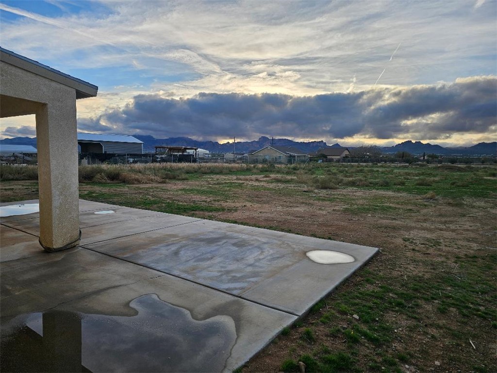 1069 Teddy Roosevelt Road Golden Valley, AZ 86413 - Photo 21 of 24 Yard at dusk featuring a patio and a mountain view