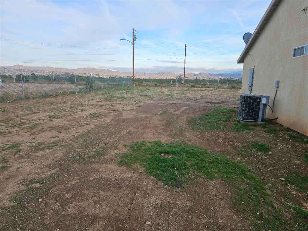 1069 Teddy Roosevelt Road Golden Valley, AZ 86413 - Photo 23 of 24 View of yard featuring a mountain view and a view of countryside