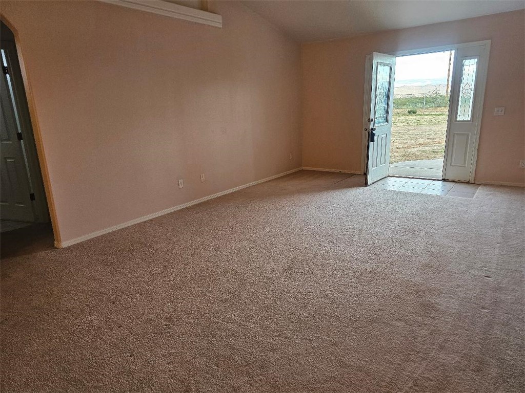 1069 Teddy Roosevelt Road Golden Valley, AZ 86413 - Photo 5 of 24 Empty room featuring light colored carpet and baseboards
