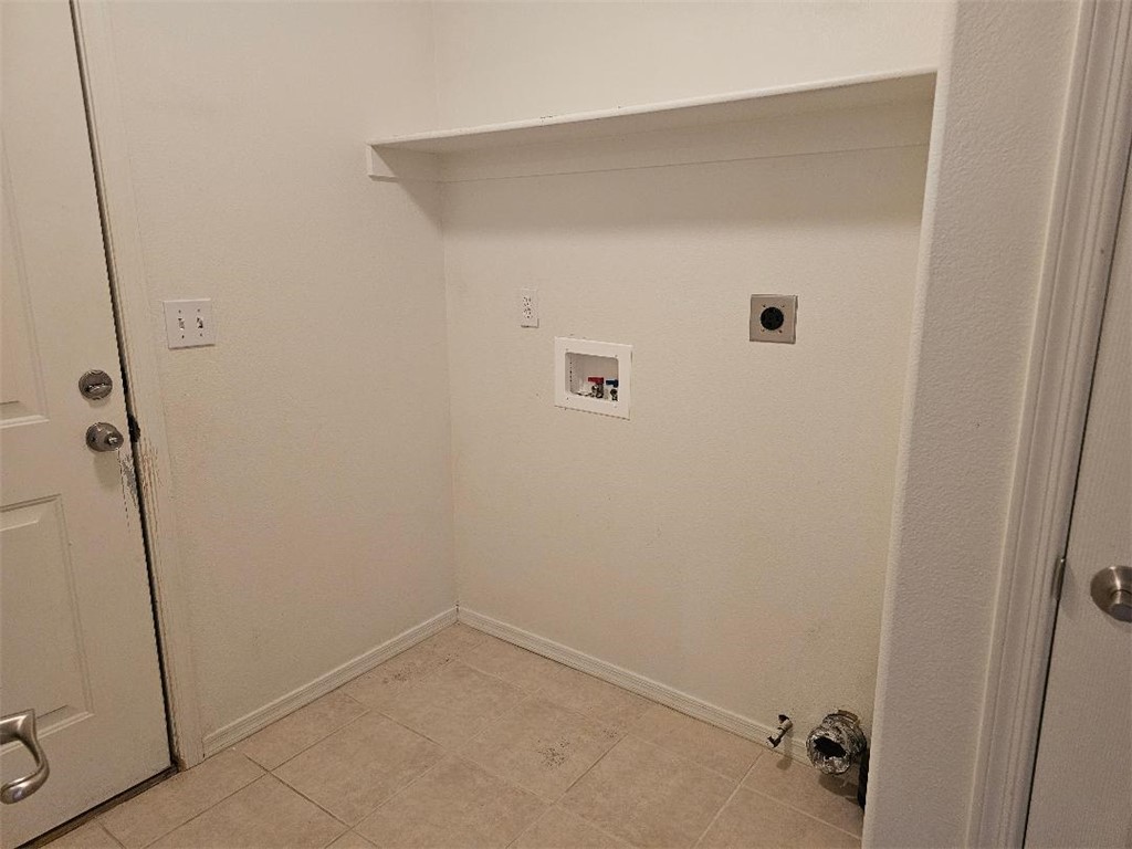 1069 Teddy Roosevelt Road Golden Valley, AZ 86413 - Photo 6 of 24 Laundry area featuring washer hookup, light tile patterned floors, and hookup for an electric dryer
