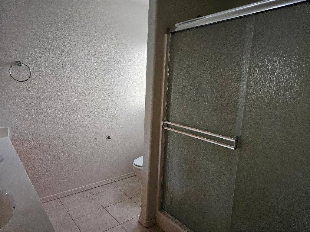 1069 Teddy Roosevelt Road Golden Valley, AZ 86413 - Photo 10 of 24 Bathroom featuring a shower stall and light tile patterned flooring