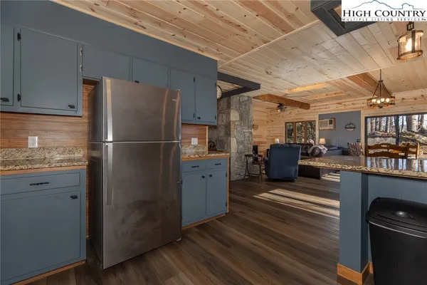 a kitchen with refrigerator and cabinets