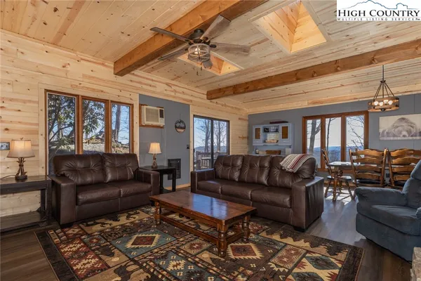 a living room with furniture ceiling fan and a rug