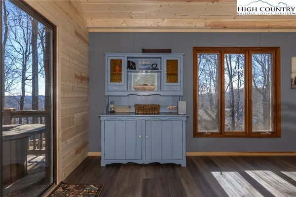 a room with wooden floor and large window