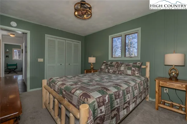 a bedroom with a bed and a lamp on table