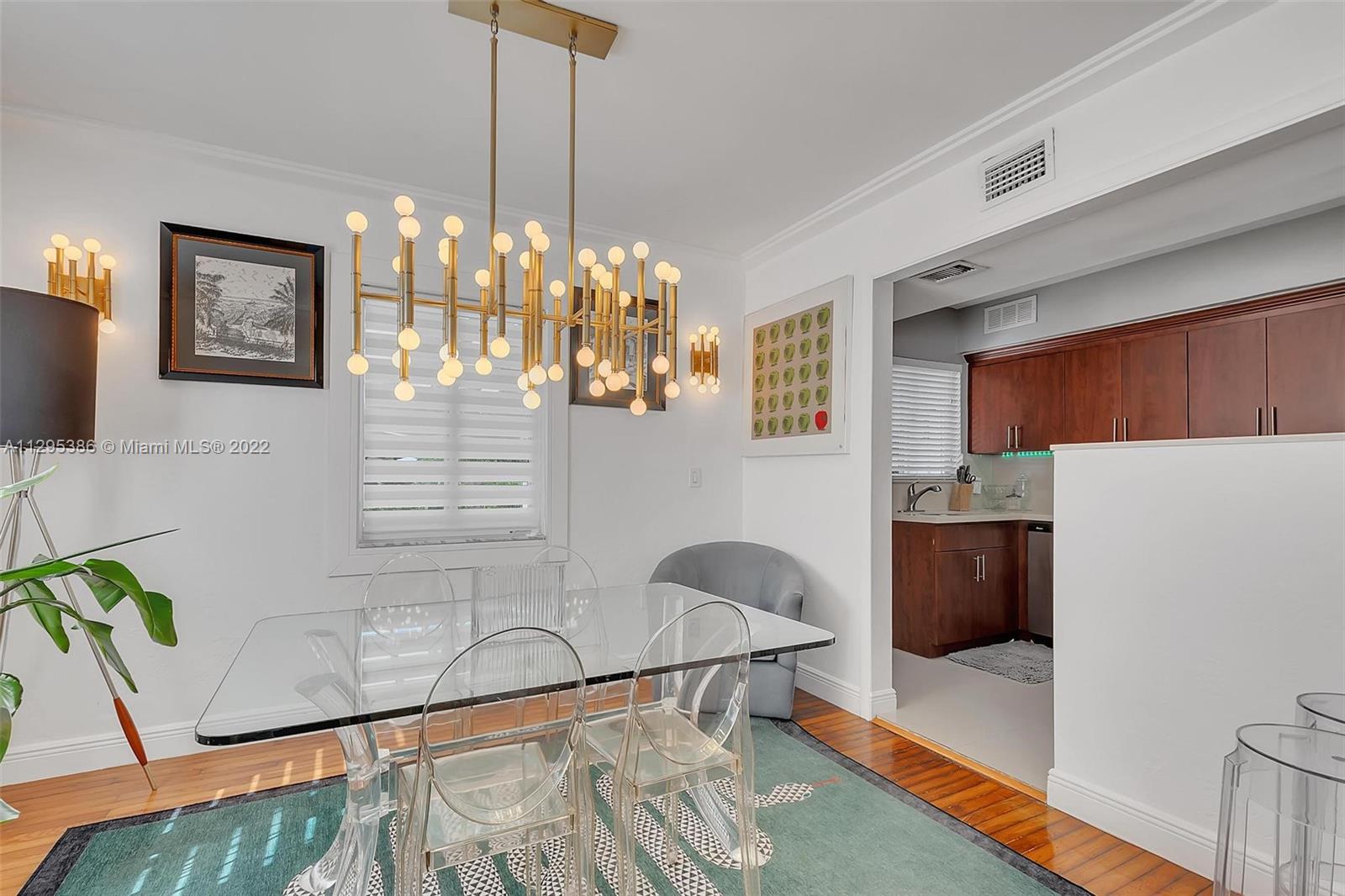1242 Southwest 13th Avenue Miami, FL 33135 - Photo 19 of 42 a dining room with furniture and a chandelier
