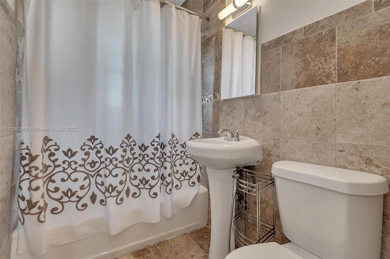 1242 Southwest 13th Avenue Miami, FL 33135 - Photo 23 of 42 a bathroom with a toilet sink and mirror