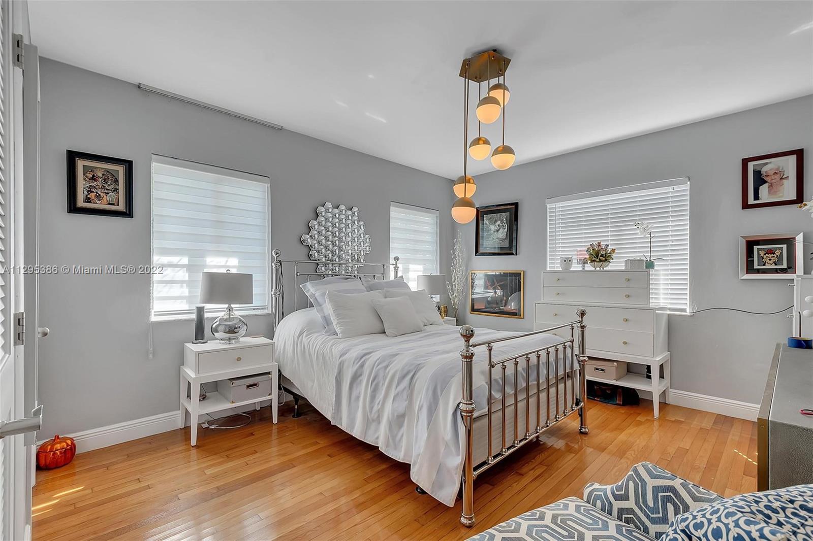 1242 Southwest 13th Avenue Miami, FL 33135 - Photo 24 of 42 a bedroom with a bed and a table in it