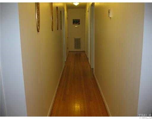 408 Roxanne Drive Raleigh, NC 27603 - Photo 5 of 7 a view of a hallway with wooden floor