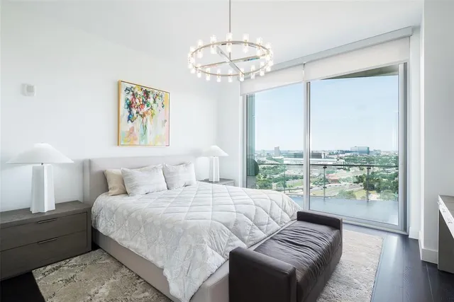 a bedroom with a large bed and a large window