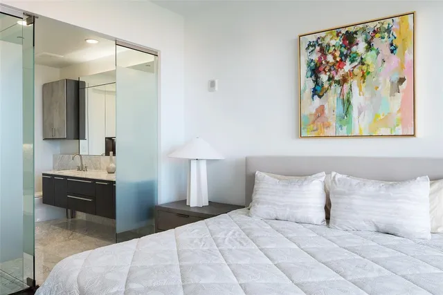 a bedroom with a bed and a painting on the wall