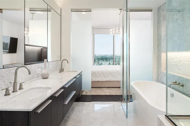 a bathroom with a tub sink and mirror