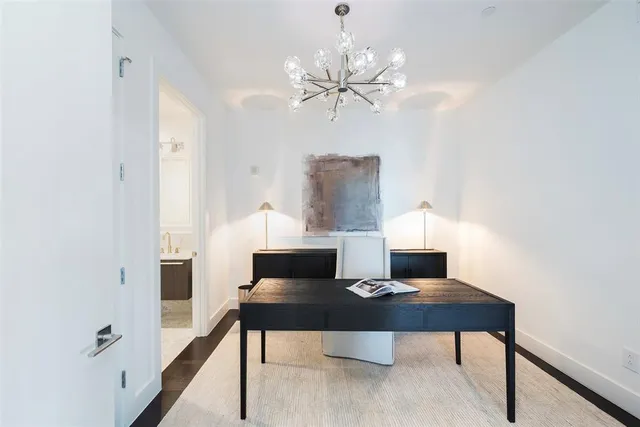 a view of a workspace with furniture and wooden floor