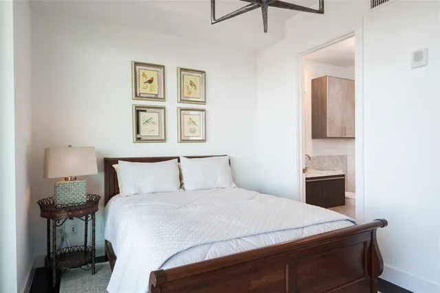 a bedroom with a bed and a painting on the wall