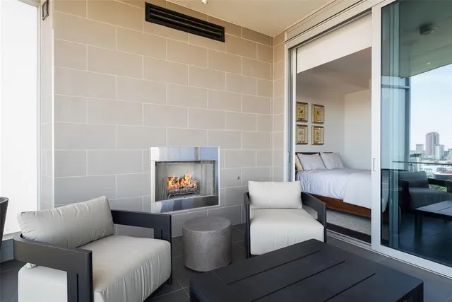 a living room with furniture and a potted plant next to a window