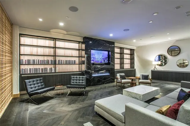 a living room with furniture a rug and a flat screen tv