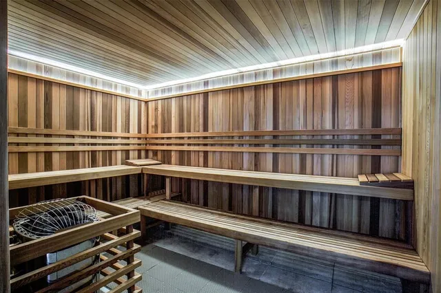 a kitchen with stairs and a wooden floor