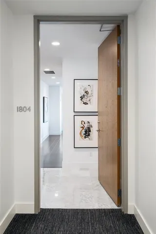 a view of a hallway with paintings on the wall