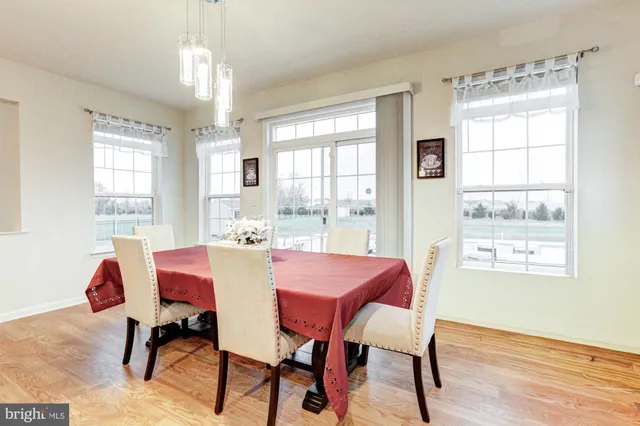 a view of a dining room with furniture and chandelier