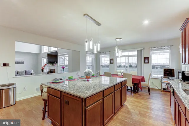 a view of a dining room with furniture and a chandelier