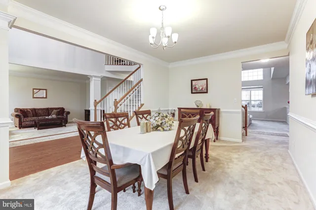 a living room with furniture a flat screen tv and kitchen view