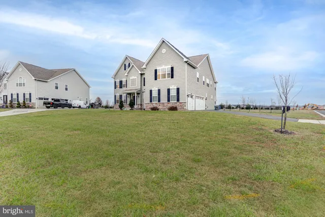 a kitchen with stainless steel appliances kitchen island granite countertop a dining table chairs and granite counter tops