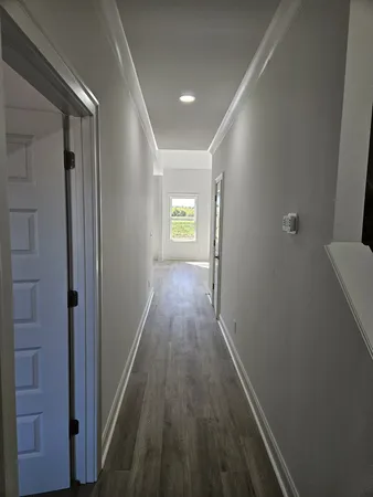 a view of hallway with wooden floor