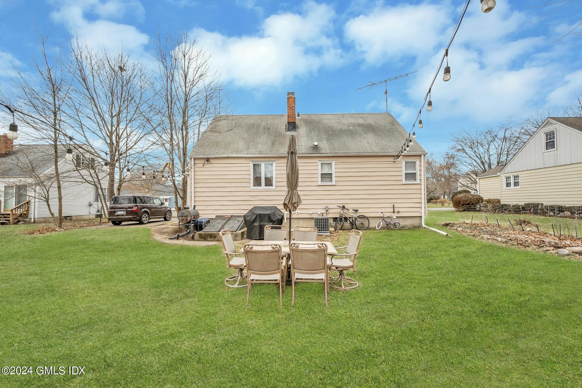 37 Leighton Road Trumbull, CT 06606 - Photo 20 of 24 a white house with a yard and sitting area