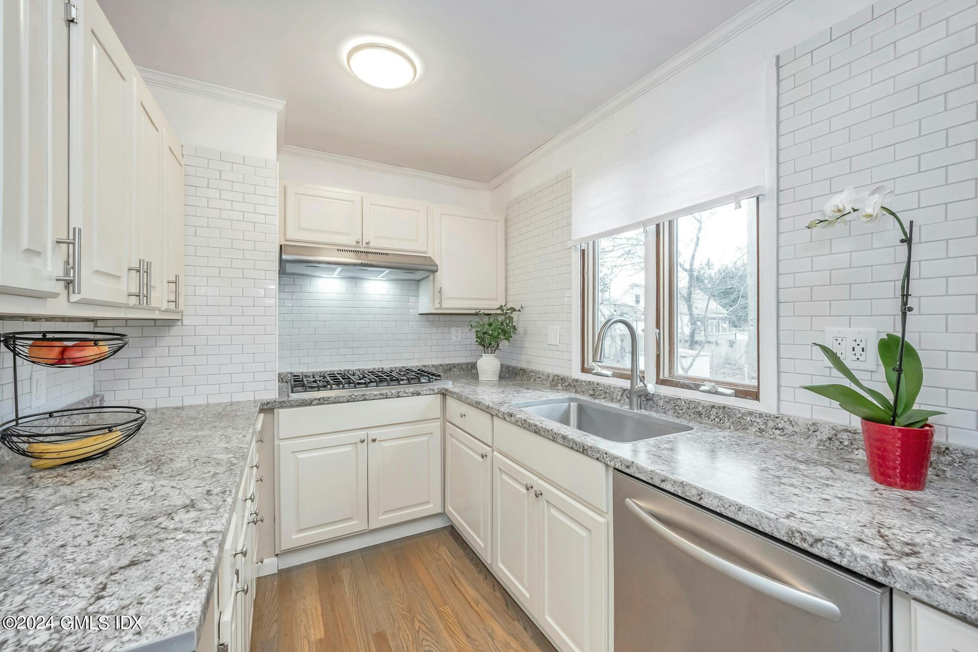 37 Leighton Road Trumbull, CT 06606 - Photo 2 of 24 a kitchen with stainless steel appliances granite countertop a sink a stove and cabinets