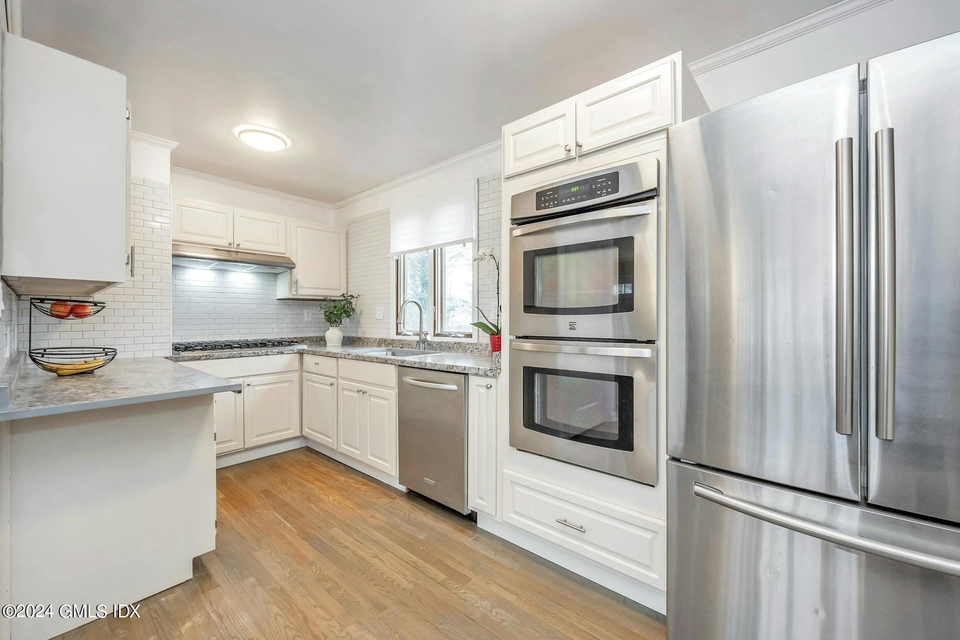 37 Leighton Road Trumbull, CT 06606 - Photo 3 of 24 a kitchen with granite countertop white cabinets and stainless steel appliances
