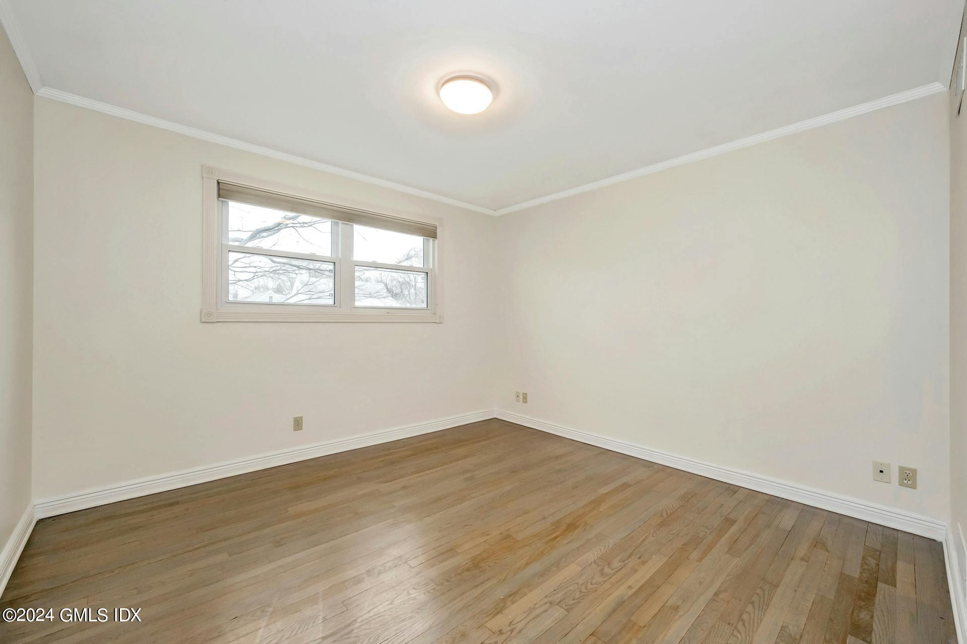 37 Leighton Road Trumbull, CT 06606 - Photo 9 of 24 an empty room with wooden floor and windows