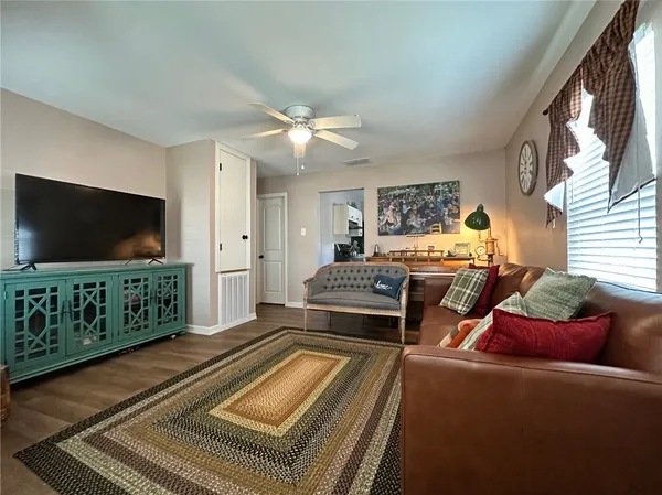 a bedroom with furniture and a flat screen tv