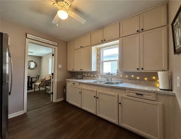 a kitchen with sink cabinets and chandelier