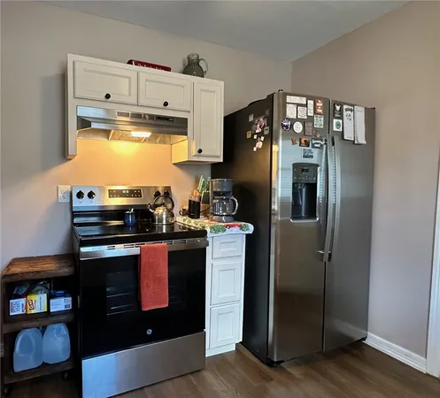 a kitchen with stainless steel appliances granite countertop a stove and a refrigerator