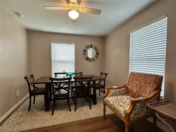 a view of a dining room with furniture and wooden floor