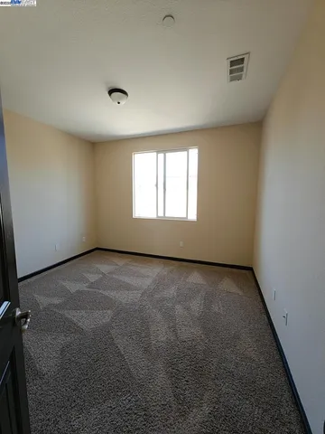 an empty room with a empty space and windows