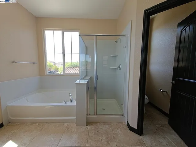 a bathroom with a bathtub and a shower
