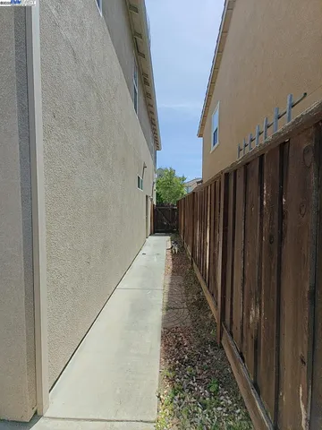 a view of a pathway gate with wooden fence