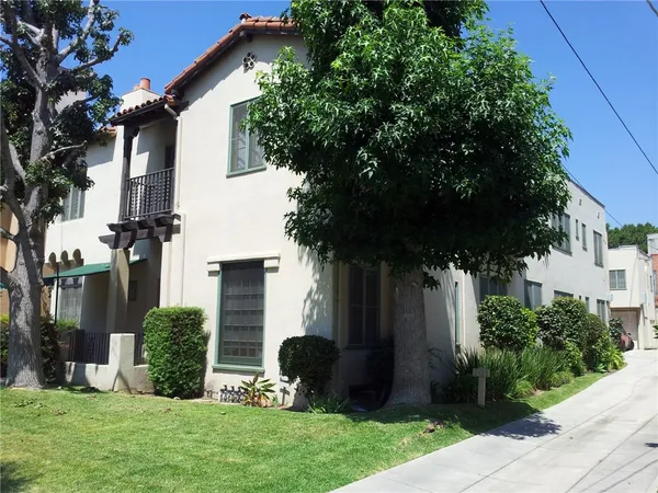 a view of a house with a yard and plants