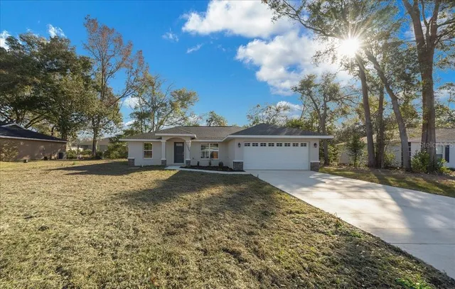 a view of a house with a yard covered with snow