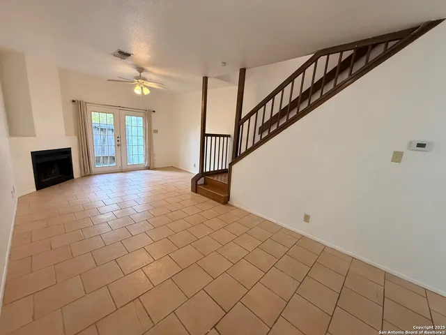a view of a livingroom with wooden floor and staircase