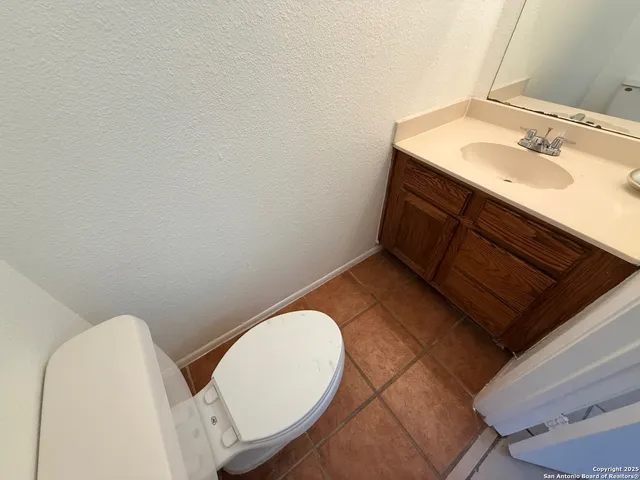 a bathroom with a sink mirror and toilet